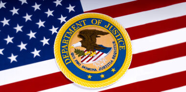 The symbol of the United States Department of Justice portrayed with the US flag