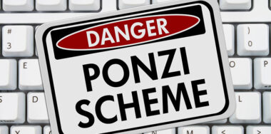 Ponzi Scheme Danger Sign on top of white keyboard