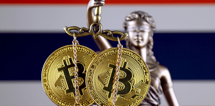 bitcoins in front of law symbol and Thailand flag