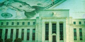 Federal Reserve building with twenty dollar bill on the horizon