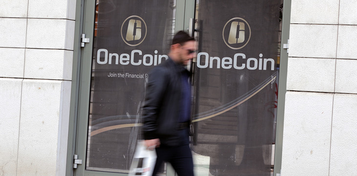 A man passes by the office of OneCoin cryptocurrency founded by Ruja Ignatova