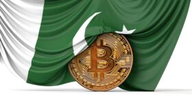 Pakistan flag draped over a bitcoin cryptocurrency