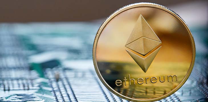 Golden ethereum coin cryptocurrency on a computer mainboard, selective focus, close-up. — Photo