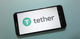 Tether (USDT) cryptocurrency logo displayed on smartphone