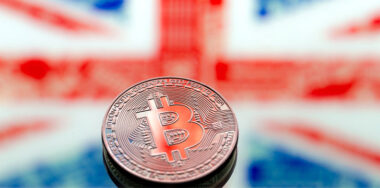 Coins Bitcoin, on a background of Great Britain and the British flag