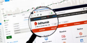 Bithumb cryptocurrency exchange website under magnifying glass Bithumb cryptocurrency exchange website under magnifying glass