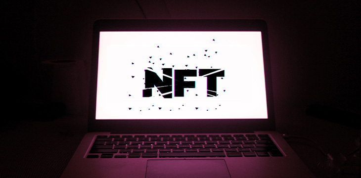 Broken NFT text on a laptop screen