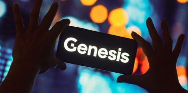 the Genesis Global Trading logo is displayed on a smartphone