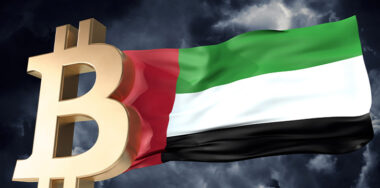 Gold bitcoin cryptocurrency with a waving UAE flag
