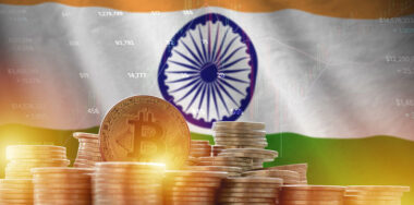 India flag and big amount of golden bitcoin coins and trading platform chart. Crypto currency concept