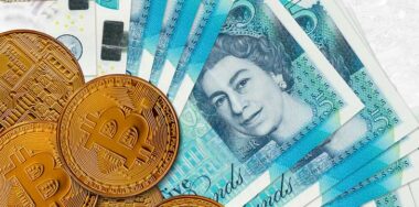 5 British pounds bills and golden bitcoins