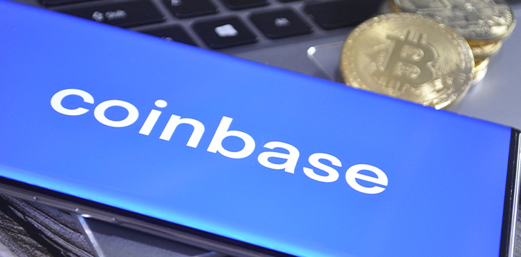 Gold and silver color shiny Bitcoins with smartphone with Coinbase logo text