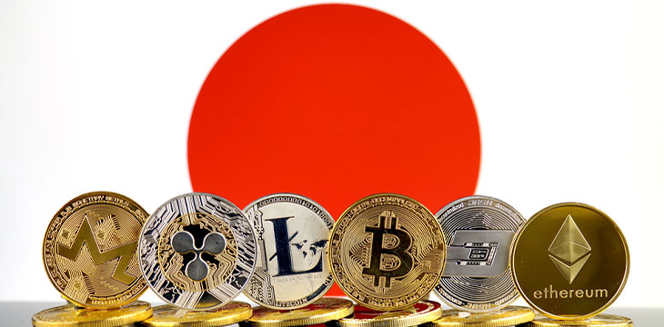 crypto currencies in front of the flag of Japan