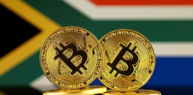Physical version of Bitcoin and South Africa Flag.