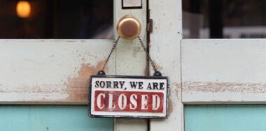 Sorry we are closed sign hanging outside a restaurant