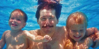 2 babies and a man swimming underwater