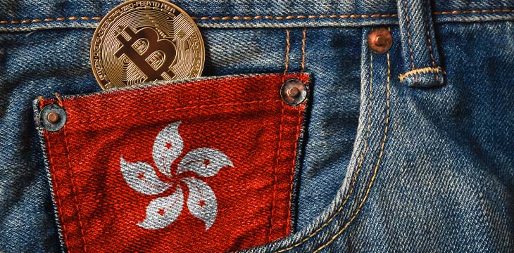 Golden BITCOIN (BTC) cryptocurrency in the pocket of jeans with the flag of Hong Kong — Stock Editorial Photography