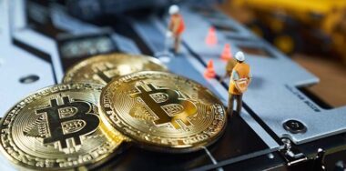 A little miner is digging on graphic card with golden coin. bitcoin mining and crypto currency concept. — Stock Editorial Photography
