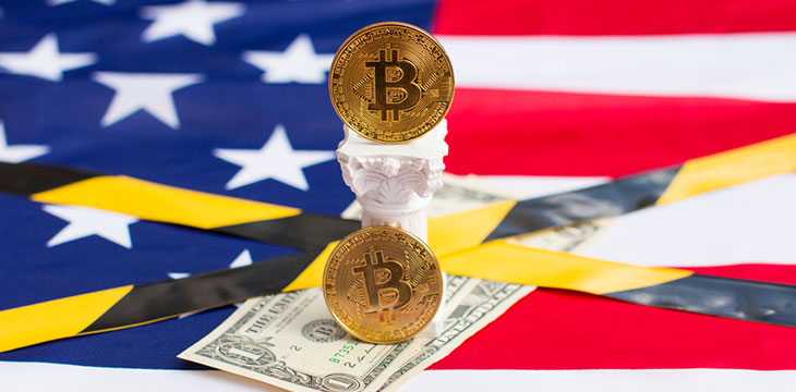Bitcoin and dollars on the American flag the fall of the US Dollar