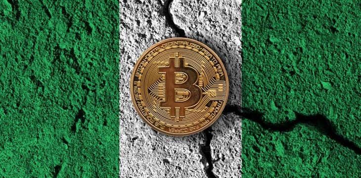 Bitcoin on a cement colored like a Nigeria Flag