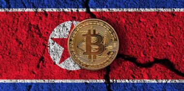 Bitcoin crypto currency coin with cracked North Korea flag