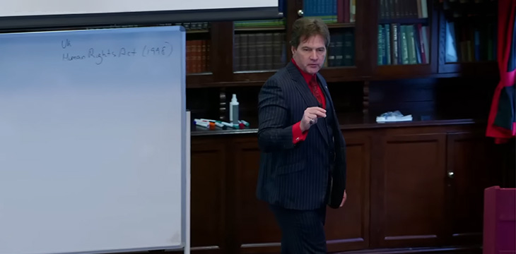 Dr. Craig Wright on the Bitcoin Masterclasses next to whiteboard