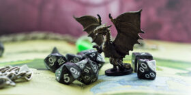 Dungeons and Dragons Colored dice and statue