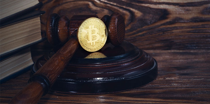 Judge's wooden gavel and Bitcoin on gavel stand