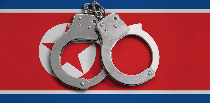 handcuffs in front of the flag of North Korea