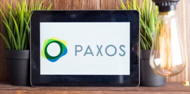a tablet showing a Paxos logo