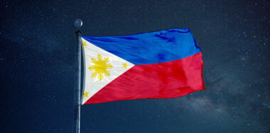 Philippine flag on the mast with starry sky background