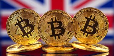 Physical version of Bitcoin (new virtual money) and UK Flag Conceptual image for investors in cryptocurrency and Blockchain Technology in United Kingdom