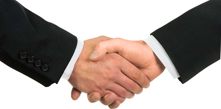 Businessmen shaking hands, isolated on white. — Photo