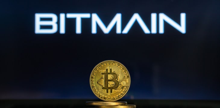 Bitmain logo on a computer screen with a stack of Bitcoin