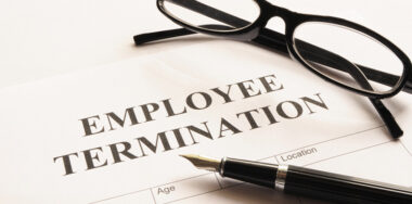 employee termination with glasses and pen