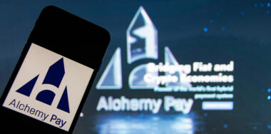 phone with Alchemy Pay logo