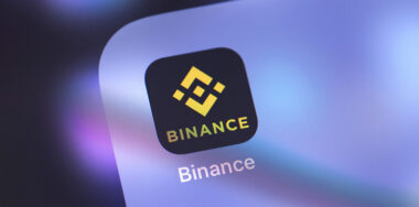 Binance icon on the screen smartphone. Binance - cryptocurrency exchange.