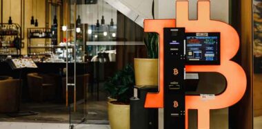 Bitcoin ATM machine in mall for cryptocurrency exchange in the evening