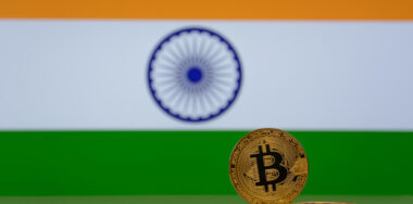 Blurred flag of India with Bitcoin in front