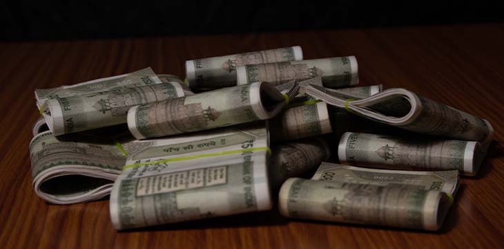 Concept of black money showing Pile of Indian currency on table in dark room. — Photo