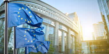 three European union flags against parliament in Brussels