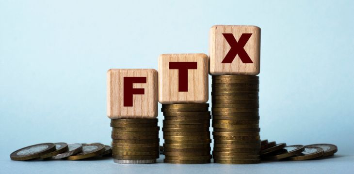 FTX letter blocks on top of stack coins