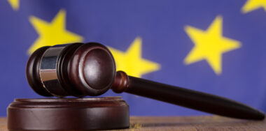 Gavel resting on sound block in front of EU flag
