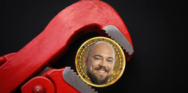 Gold Bitcoin and red spanner with face of Kurt Wuckert Jr. on the coin