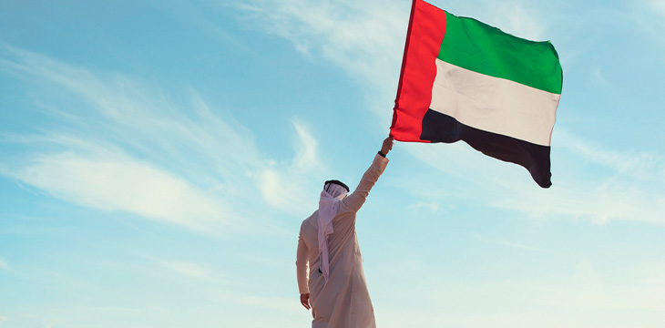 arabian Emirati man holding a UAE flag