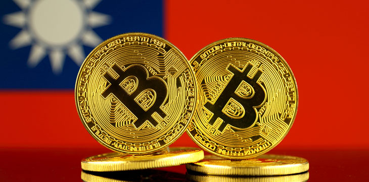 close up photo of physical version of Bitcoin and Taiwan Flag