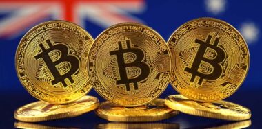 Physical version of Bitcoin inf ront of Australia Flag