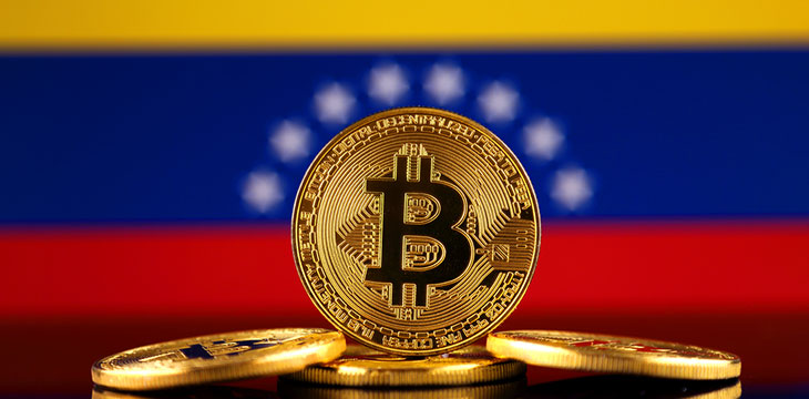 Physical version of Bitcoin (new virtual money) and Venezuela Flag. Conceptual image for investors in cryptocurrency and Blockchain Technology in Venezuela