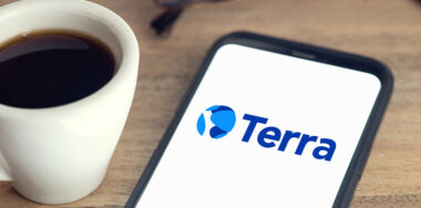 coffee and phone with terra logo on screen