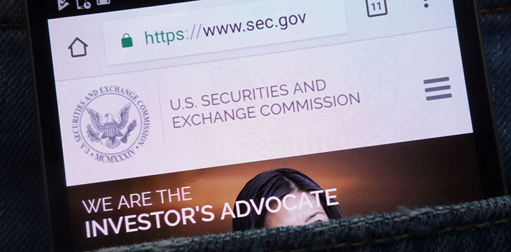 U.S. Securities and Exchange Commission website displayed on smartphone hidden in jeans pocket
